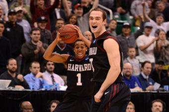 Siyani Chambers and Laurent Rivard of the Harvard Crimson celebrate as the Crimson defeat the New Mexico Lobos 68-62 during the the 2013 NCAA Men's Basketball Tournament on Thursday in Salt Lake City, Utah. Harry How/Getty Images