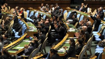 Delegates to the United Nations General Assembly applaud the passage of the first U.N. treaty regulating the international arms trade on Tuesday. Timothy A. Clary /AFP/Getty Images