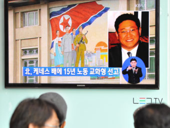 Passersby watch a local television broadcast in Seoul on Thursday showing a report on the sentencing of Kenneth Bae. Kim Jae-hwan/AFP/Getty Images