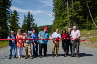 Senator Dennis Egan, Representative Cathy Munoz, General Manager of Kensington Gold Mine Wayne Zigarlick, Mayor Merrill Sanford, Gov. Sean Parnell, Chair of the Goldbelt Board of Directors Cheryl Eldemar, Local 71 Representative Tom Brice, and DOT Commissioner Pat Kemp cut the ribbon.