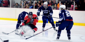 Juneau center Ethan Seid kicks up some ice while finding himself in a crowd of Soldotna players during the weekend series at Treadwell Ice Arena.