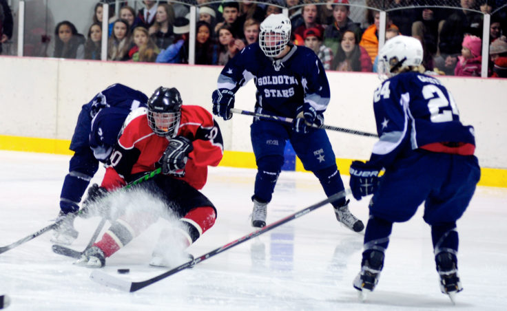 Juneau center Ethan Seid kicks up some ice while finding himself in a crowd of Soldotna players during the weekend series at Treadwell Ice Arena.