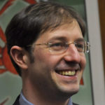 Jesse Kiehl, aide to Sen. Dennis Egan, interacts with a visitor to the senator's office, Feb, 10, 2014. (Photo by Skip Gray/Gavel Alaska)