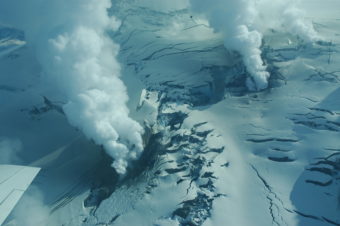 Views of Fourpeaked volcano and area of volcanic activity on the north flank in 2006. (Photo by Christina Neal. Courtesy of Alaska Volcano Observatory / U.S. Geological Survey)