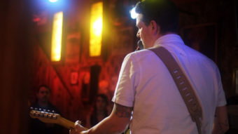 Morgan Deering playing guitar at the Alaskan