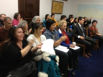 The Barnes Committee Room erupts in applause after an Alaska House committee advanced legislation that would make 20 Alaska Native languages official state languages on Feb. 18, 2014.