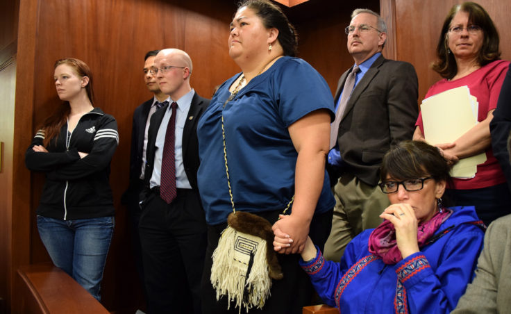 In the Senate gallery, an emotional Rep. Charisse Millett holds hands with Liz Medicine Crow while Senators debate the fate of the bill. The legislation, which passed moments later, makes 20 Alaska Native languages official state languages alongside English. (Photo by Skip Gray/Gavel Alaska)