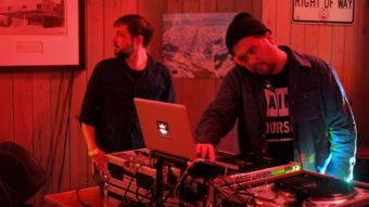 A man DJs on a computer