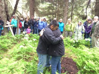 Martin Stepetin and wife Ann embrace when Martin breaks down in tears. Originally from St. Paul, Stepetin has family members who were interned in Funter Bay, 50 miles north of Killisnoo. (Photo by Lisa Phu/KTOO)