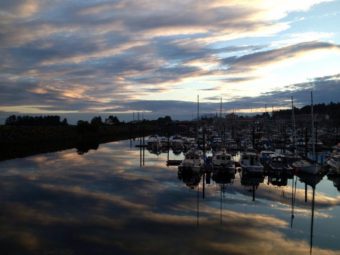 A July sunset from the Sea Walk “spur” on Crescent Harbor. The city’s insurer requires a guardrail to be built here. Photo courtesy KCAW/Shaleece Haas)