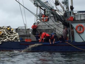 Coast Guard Station Ketchikan boarding team members help the crew of the fishing vessel Vernon dewater their engine room near Ketchikan on Friday. (Photo courtesy U.S. Coast Guard Station Ketchikan)