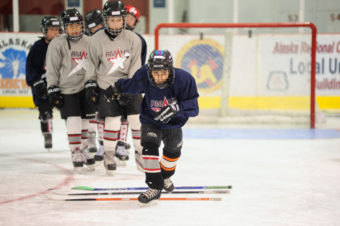 Sunny Monset participates in a drill consisting of stepping over evenly spaced hockey sticks then break into a sprint.