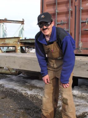 Raven researcher Stacia Backensto disguises herself as an oilfield worker in an attempt to fool ravens she has captured before. (Photo by Jim Zelenak)