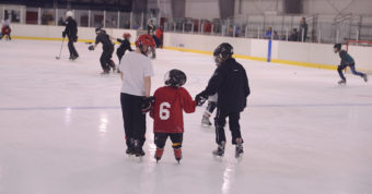 (From left) Gabe Miller and Karter Kolhase help Jed Davis enjoy an afternoon of skating and hockey during a Learn to Play afternoon sponsored by the Juneau Douglas Ice Association and Treadwell Ice Arena.