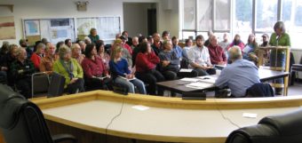 A Senate staffer listens to testimony from Petersburg residents in 2010. (KFSK file photo)