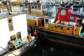The Eyak bids goodbye to the tugboat Marauder, which brought it into Sitka Channel. (Photo by Rachel Waldholz/KCAW)