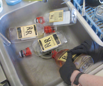 Empty alcohol bottles in a sink