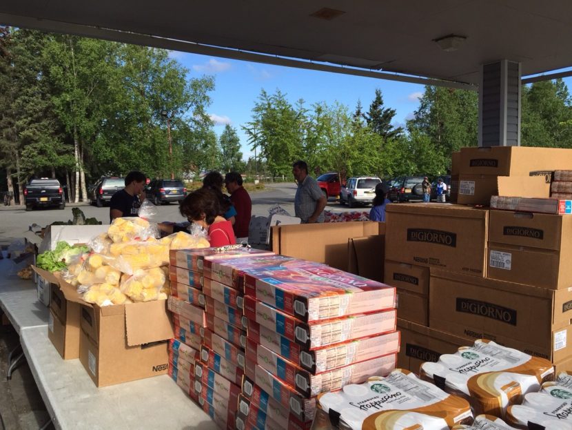 Volunteers help set up for the food pantry at Muldoon Community Assembly Church in Anchorage. (Photo by Anne Hillman/KSKA)