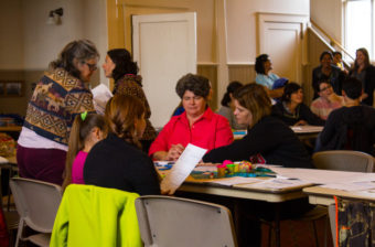Parents, teachers, and other community members discuss results from the 2015 School Climate and Connectedness Survey during Community Night on Aug. 17. (Photo by Laura Kraegel, KNOM)