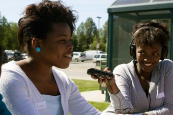 Olive Mtoni records Furaha Sefania outside of UAA. (Photo courtesy of ATMI.)
