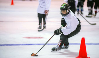 Sam Bovitz maneuvers the puck around a pylon before skating up ice toward the goal for a shot. (Photo by Steve Quinn)