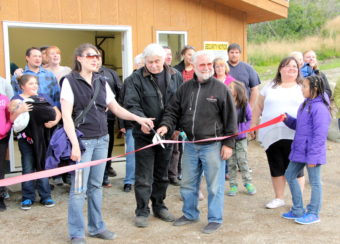 Project manager Michelle Anderson, Village President Clemens Grunert Jr., and Lake and Pen Borough Mayor Glen Alsworth pose for a photo at the official ribbon cutting of the Packer Creek hydro project. (Photo by Hannah Colton/KDLG)