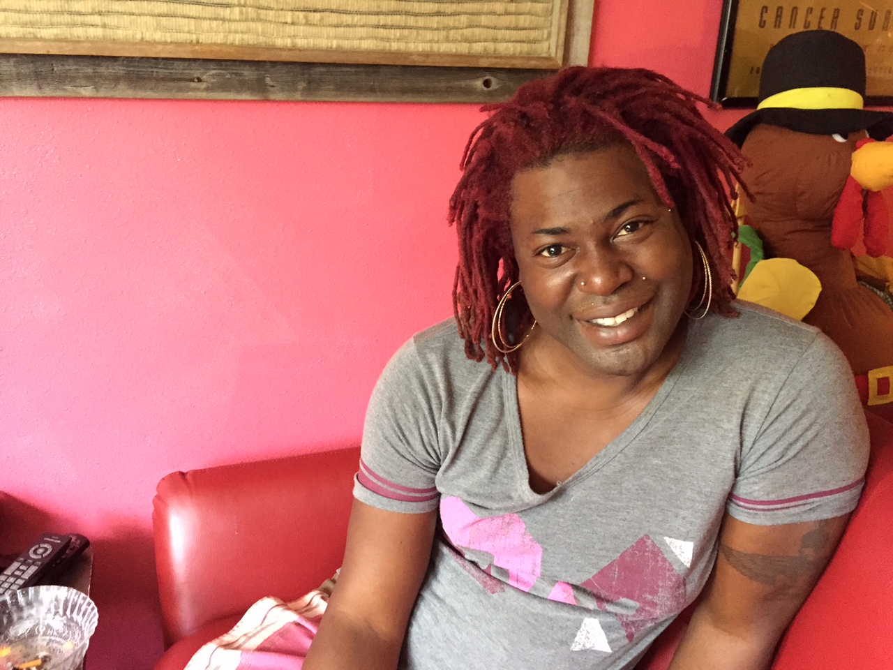 MoHagani Magnetek poses in her apartment. (Photo by Anne Hillman/KSKA)