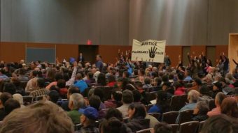 Protestors shouts out in support of the Fairbanks Four during Gov Bill Walker's address to the Alaska Federation of Natives convention. (Photo by Jennifer Canfield/KTOO)