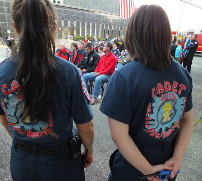 Firefighters of tomorrow, Lisa Palmer and Elizabeth Rodriguez-Moreno, stand ready to light candles during Saturday's observance. (Photo by Matt Miller/KTOO)