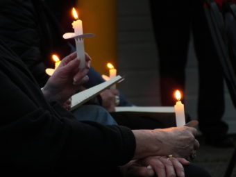 Candles are lit as Juneau firefighters read the names of those who've perished. (Photo by Matt Miller/KTOO)