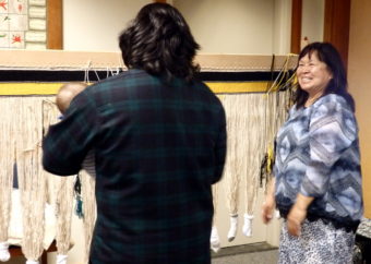 Weaver Darlene See and her healing robe. (Photo by Jillian Rogers/KHNS)