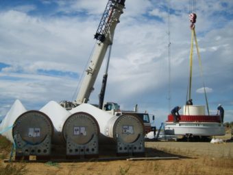 Alaska Environmental Power workers and contractors prepare to hoist the hub of a rotor and the three large blades to the hub to the left Sept. 3 for the Delta Wind Farm’s second 900-megawatt wind generator. (Photo by Tim Ellis/KUAC)