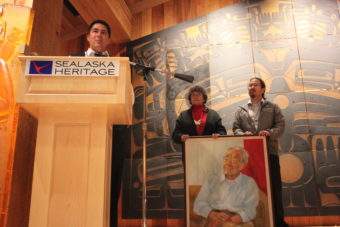 Sealaska Corporation CEO Anthony Mallott remembers Dr. Walter Soboleff. SHI board chair Marlene Johnson and Sealaska board chair Joe Nelson stand by a portrait of Soboleff. (Photo by Lisa Phu/KTOO)