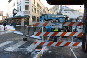 Construction workers move concrete blocks to create a buffer area around the Gastineau Apartments. (Photo by Elizabeth Jenkins/KTOO)