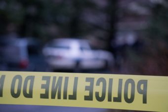 Juneau Police Department officers watch the perimeter of a cordoned off the area around the Admiralty condos in West Juneau on Nov. 15, 2015. Two murder victims, Robert Meireis and Elizabeth Tonsmeire, were discovered inside one of the condos.