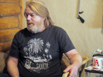 Scott Harrison spends most of each day on a hospital bed that stopped working after a water-leak this fall shorted it out. (Photo by Zachariah Hughes/KSKA)
