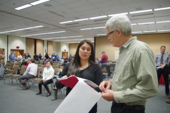 Clark's Point set-netter Alannah Hurley talks to Board of Fisheries chair Tom Kluberton about her proposal, which would have allowed setnetters to extend their nets to recoup some fishing time that has been lost as the mudflats fill in there. The board formed a committee to help develop guidelines for addressing coastal change, rather than taking action on that proposal or another that discussed set-net site boundaries. (Photo by Molly Dischner/KDLG)