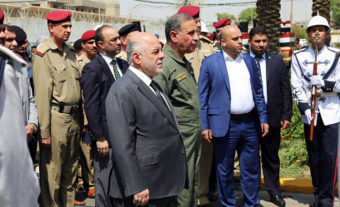 Iraqi Prime Minister Haider al-Abadi (center) attends a funeral for two generals killed in fighting with Islamic State militants in Ramadi, west of Baghdad, in August. In an interview Monday with NPR, the Iraqi leader called on the U.S. to provide more airstrikes but said his country does not want ground forces from the U.S. or any other country. AP