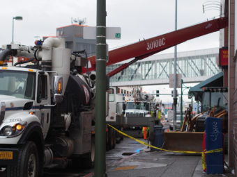 Municipal Light and Power crews work on digging through cement to reach a malfunctioning transformer knocked out during the earthquake, interrupting power to the 5th Avenue Mall. (Photo by Zachariah Hughes/KSKA)