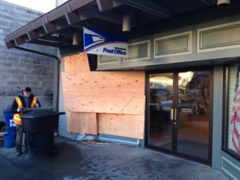 In addition to crushing the storefront, the SUV hit a parked car, a street sign, and ran over the mailbox. (Photo by Robert Woolsey/KCAW)