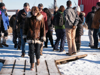 US Sen. Lisa Murkowski walking through Oscarville, followed by U.S. Sen. John Barrasso and AVCP Executive Vice President Mike Hoffman. (Photo by Dean Swope/KYUK)