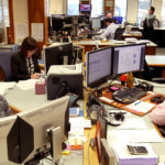 Alaska Permanent Fund Corp. staff work in the fund's nerve center, March 14, 2016. About 40 employees are responsible for managing the $50 billion fund. From front to back: Real Estate Analyst Christi Grussendorf, Research and Operations Assistant Moctar Diouf, Real Estate Analyst Karen Emberton, Fixed Income Credit Analyst Matt Olmsted and Senior Portfolio Manager Chris Cummins. Laura Achee, director of communications and administration, stands in the background. (Photo by Skip Gray/360 North)