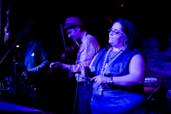 A picture Colette Costa playing the triangle with the North Country Cajun Club at the Red Dog Saloon on Friday, Feb. 5, 2016. (Photo by Annie Bartholomew/KTOO)