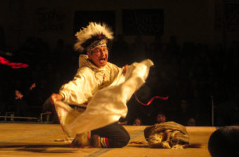 One performer leads the Nunamta Yup’ik Singers and Dancers at the 2016 Cama-i Dance Festival in Bethel. (Photo by Laura Kraegel/KNOM)