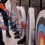 Participants remove arrows from the targets in the archery event during the 19th Annual Legislative Team Shoot. (Photo by David Purdy/KTOO)