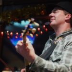A photo of Jeremy Kane of the Great Alaska Bluegrass Band performing at Squires. (Photo By Annie Bartholomew/KTOO)