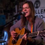 A picture of Liz Snyder Playing acoustic guitar.