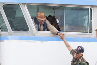 Doug Chilton, head of the One People Canoe Society, shares a laugh with Dennis Jack on Wednesday, June 8, 2016, near Juneau, Alaska. The One People Canoe Society began a canoe trip to Juneau from Angoon on June 2. Their landing on Douglas Island is the unofficial beginning of Celebration. (Photo by Rashah McChesney/KTOO)
