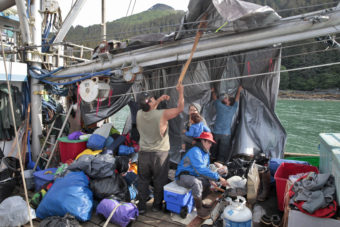 Members of the One People Canoe Society prepare their safety boat before hopping into canoes to finish paddling from Angoon to Juneau on Wednesday, June 8, 2016, near Juneau, Alaska. The society began the trip on June 2. Their landing on Douglas Island is the unofficial beginning of Celebration. (Photo by Rashah McChesney/KTOO)