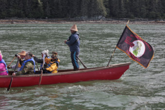 Members of the One People Canoe Society work during the last leg of their trip from Angoon to Juneau on Wednesday, June 8, 2016, near Juneau, Alaska. The society began the trip on June 2. Their landing on Douglas Island is the unofficial beginning of Celebration. (Photo by Rashah McChesney/KTOO)